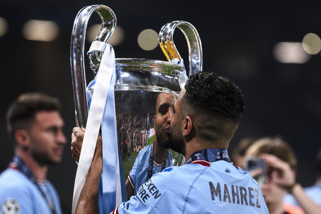 Riyad Mahrez of Manchester City FC kisses the trophy during