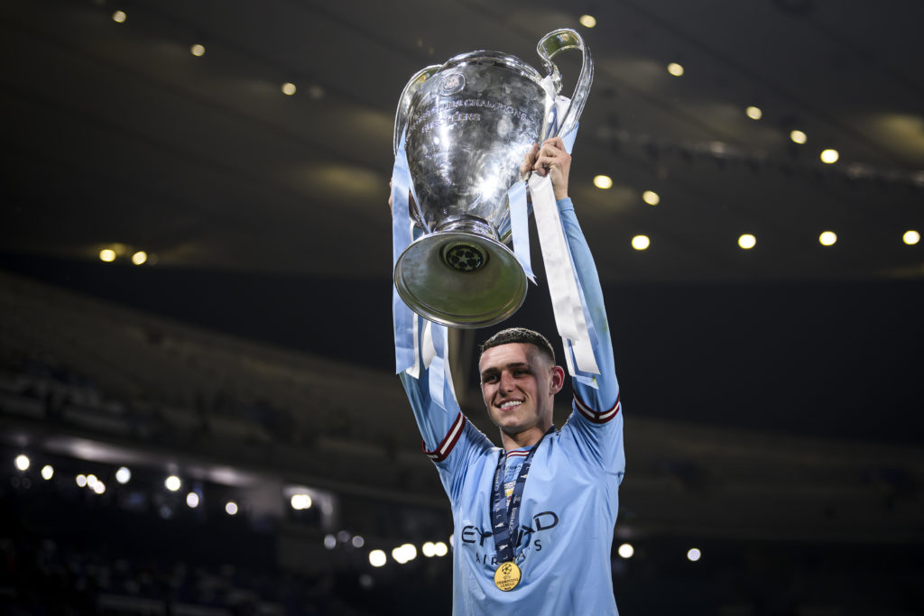 Phil Foden of Manchester City FC celebrates with the trophy
