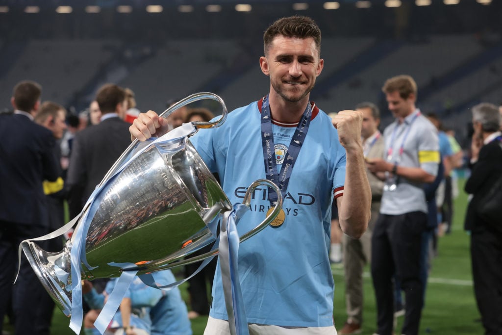 Aymeric Laporte holds the Champions League trophy after Inter Milan vs Manchester City