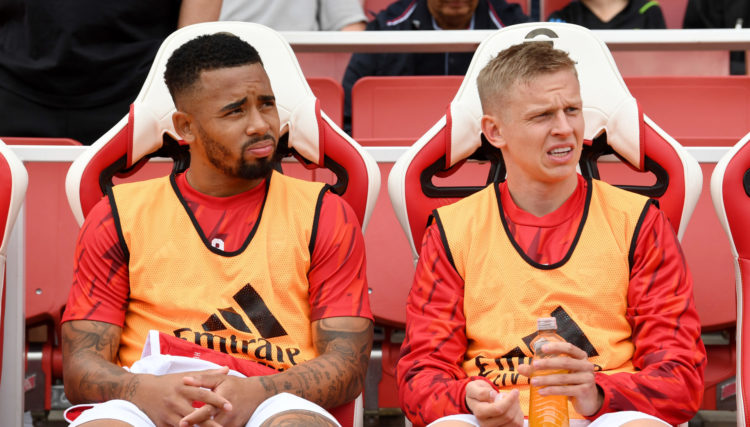 L and Oleksandr Zinchenko of Arsenal look on from the substitutes bench prior to the Premier League match between Arsenal FC and Fulham FC at Emirates Stadium on August 26, 2023 in London, England. (Photo by David Price/Arsenal FC via Getty Images