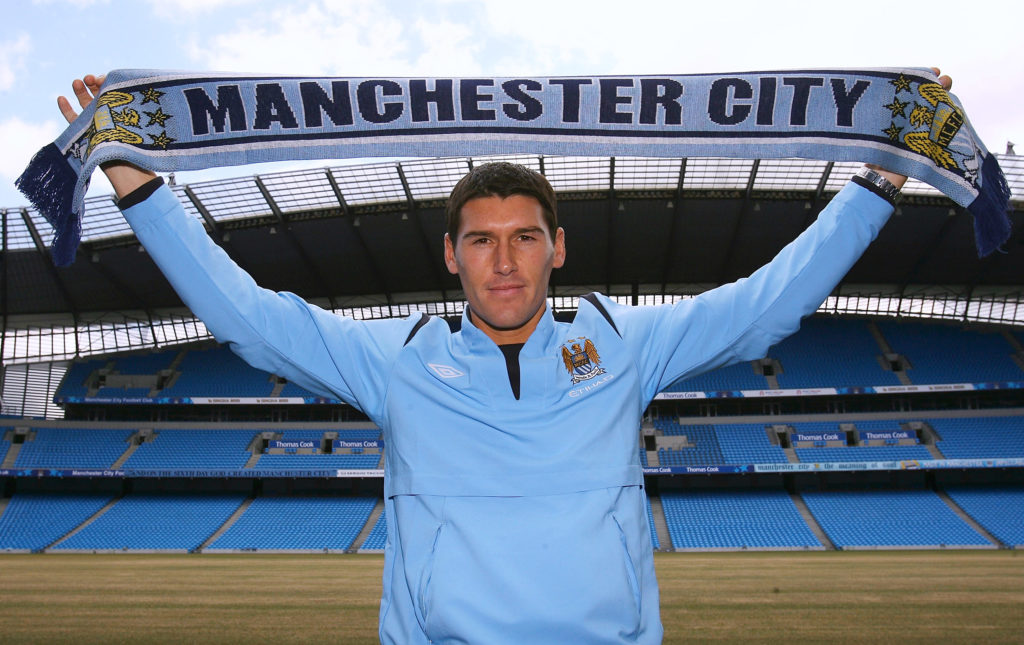 New Manchester City signing Gareth Barry holds a scarf as he is unveilled during a Press conference at the City of Manchester Stadium on June 11, 2009