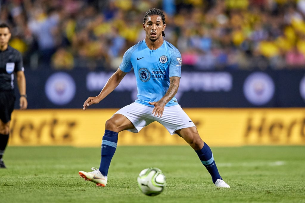 Douglas Luiz in action for Man City.