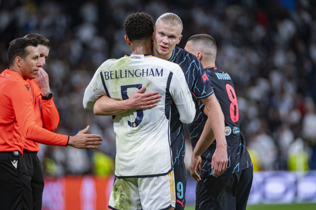 Erling Haaland of Manchester City (R) hugs Jude Bellingham of Real Madrid (L) during the UEFA Champions League quarter-final first leg match between Real Madrid CF and Manchester City at Estadio Santiago Bernabeu on April 9, 2024