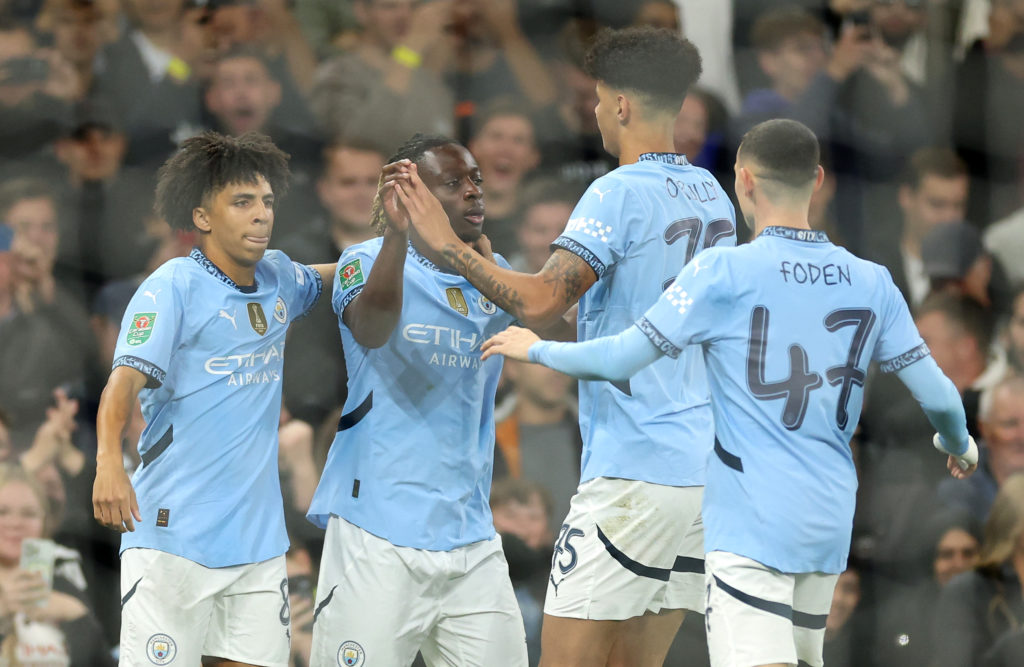 Jeremy Doku of Manchester City (second left) celebrates with teammates Rico Lewis, Nico O'Reilly and Phil Foden after scoring his team's first goal during the Carabao Cup Third Round match between Manchester City and Watford at Etihad Stadium on September 24, 2024