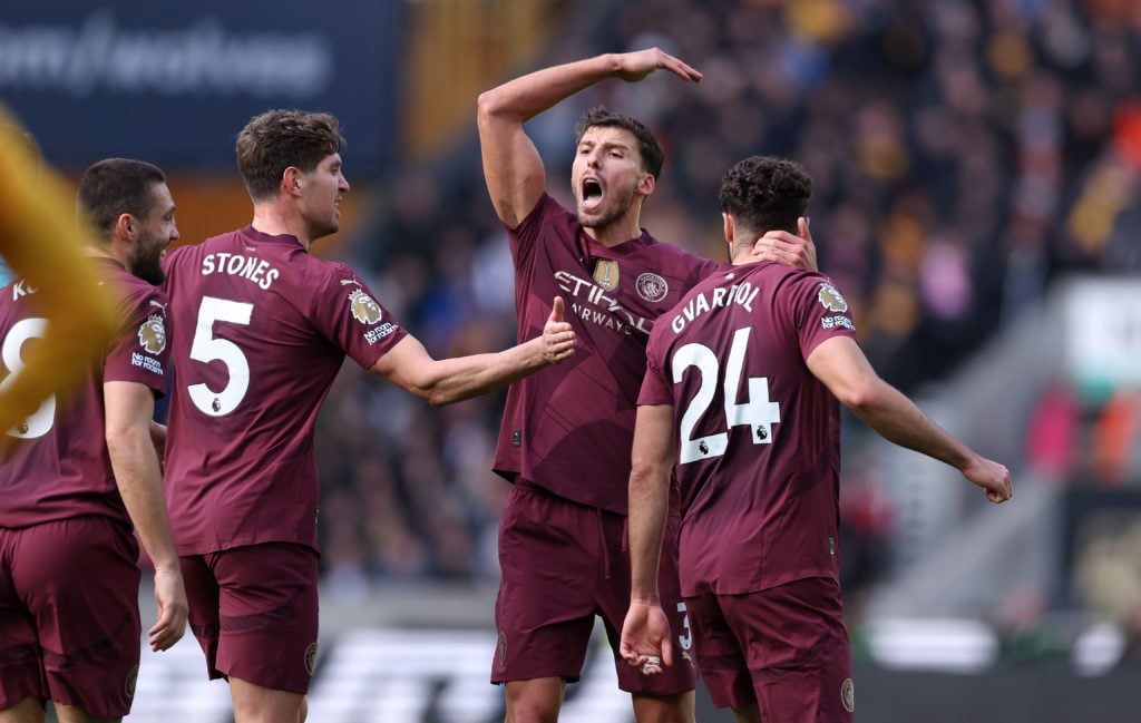 Josko Gvardiol of Manchester City celebrates with Ruben Dias and John Stones after scoring their first goal during the Premier League match between Wolverhampton Wanderers FC and Manchester City FC at Molineux on October 20, 2024 in Wolverhampton, England.