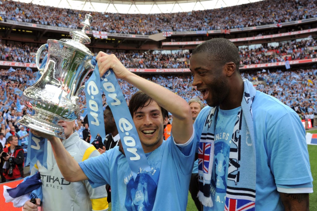 David Silva and Yaya Toure of Man City celebrate with the trophy during the The FA Cup sponsored by E.0N 2011 Final match between Manchester City and Stoke City at Wembley Stadium on May 14, 2011