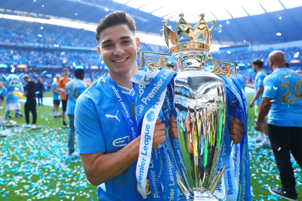 Julian Alvarez of Manchester City holds the trophy after the Premier League match between Manchester City and West Ham United at Etihad Stadium on May 19, 2024 in Manchester, England