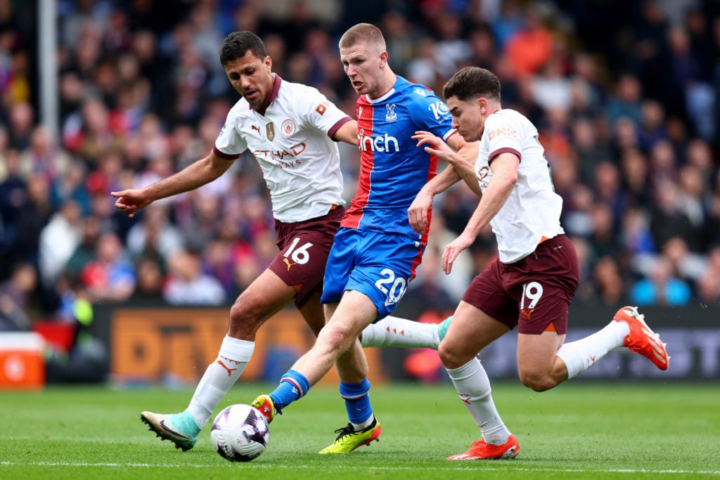 Adam Wharton passing the ball with Rodri and Julian Alvarez pressing him