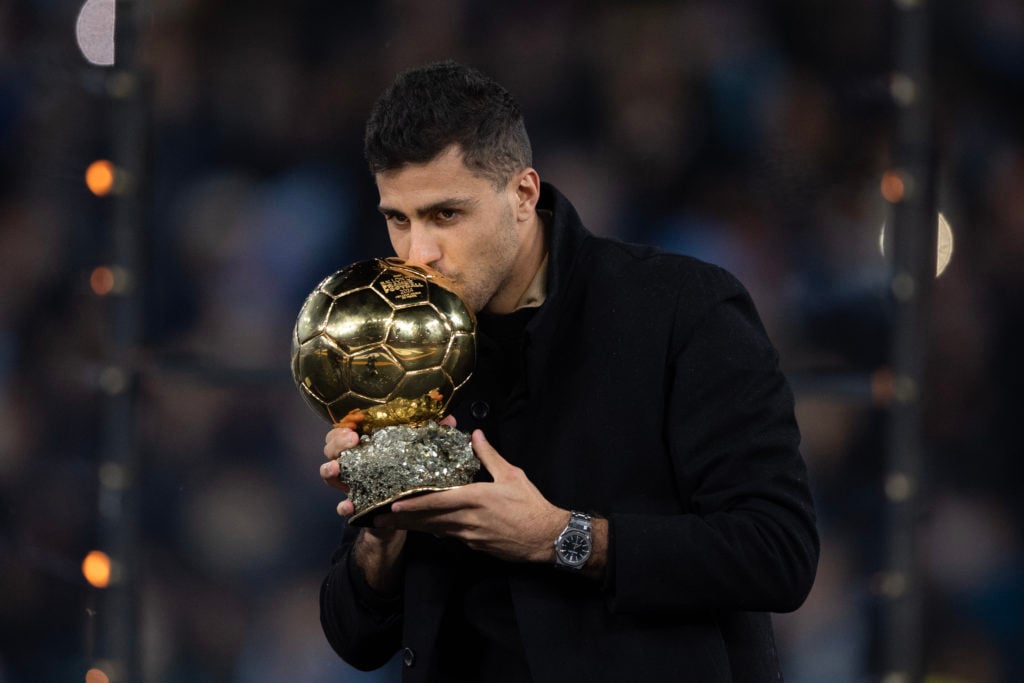 Rodri kisses his Ballon d'Or before Manchester City v Tottenham Hotspur.