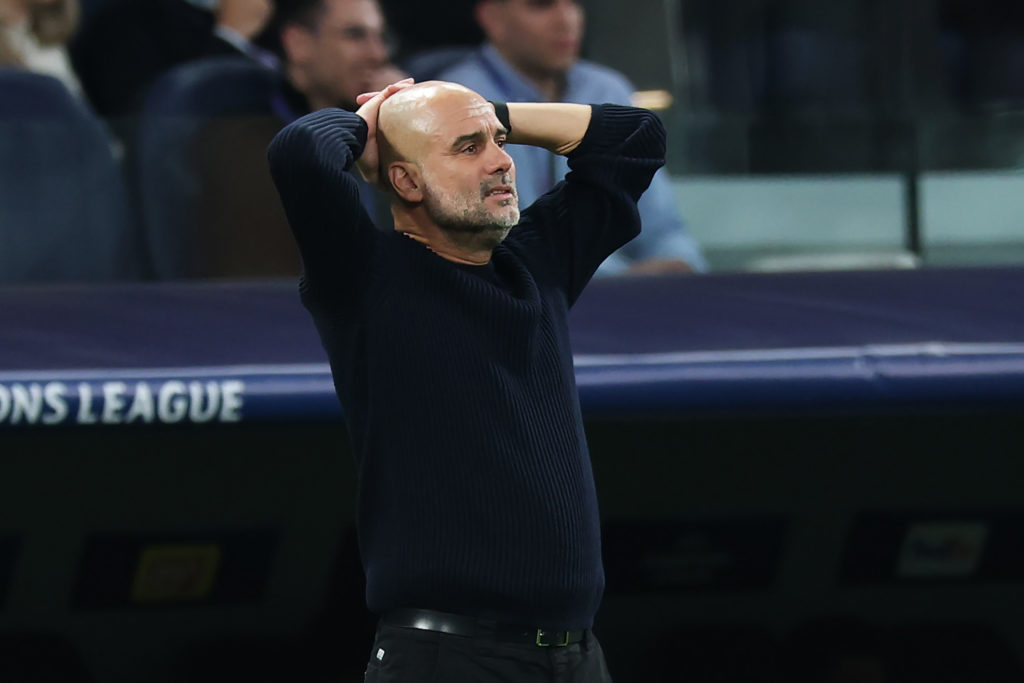 Pep Guardiola with his head in his hands during Manchester City vs Real Madrid