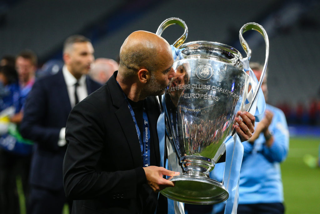 Pep Guardiola kissing the Champions League trophy.
