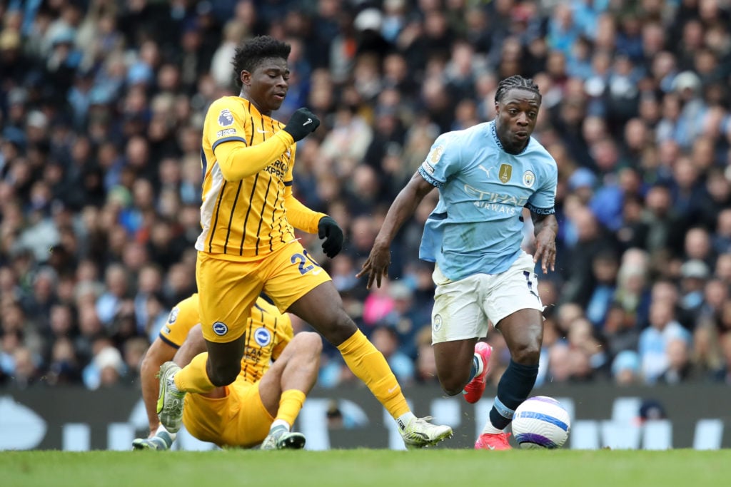 Jeremy Doku of Manchester City and Carlos Baleba of Brighton & Hove Albion during the Premier League match between Manchester City FC and Brighton & Hove Albion FC at Etihad Stadium on March 15, 2025