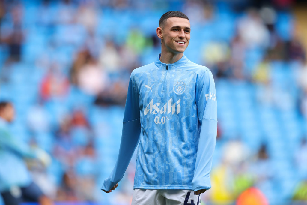 Phil Foden warms up ahead of Manchester City v Brentford.