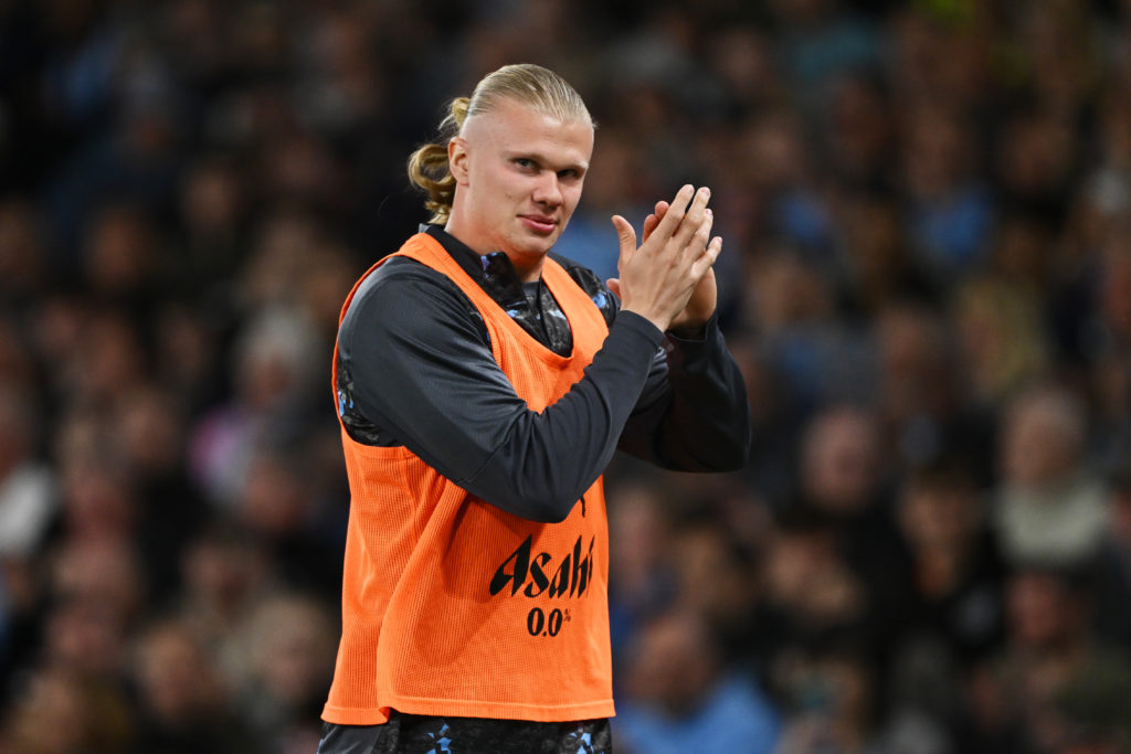 Erling Haaland clapping his hands in a Man City tracksuit