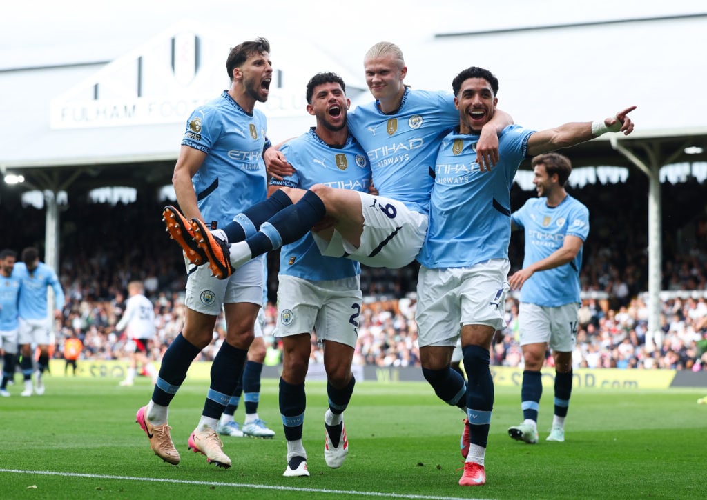 Manchester City players celebrate after Erling Haaland scores against Fulham.