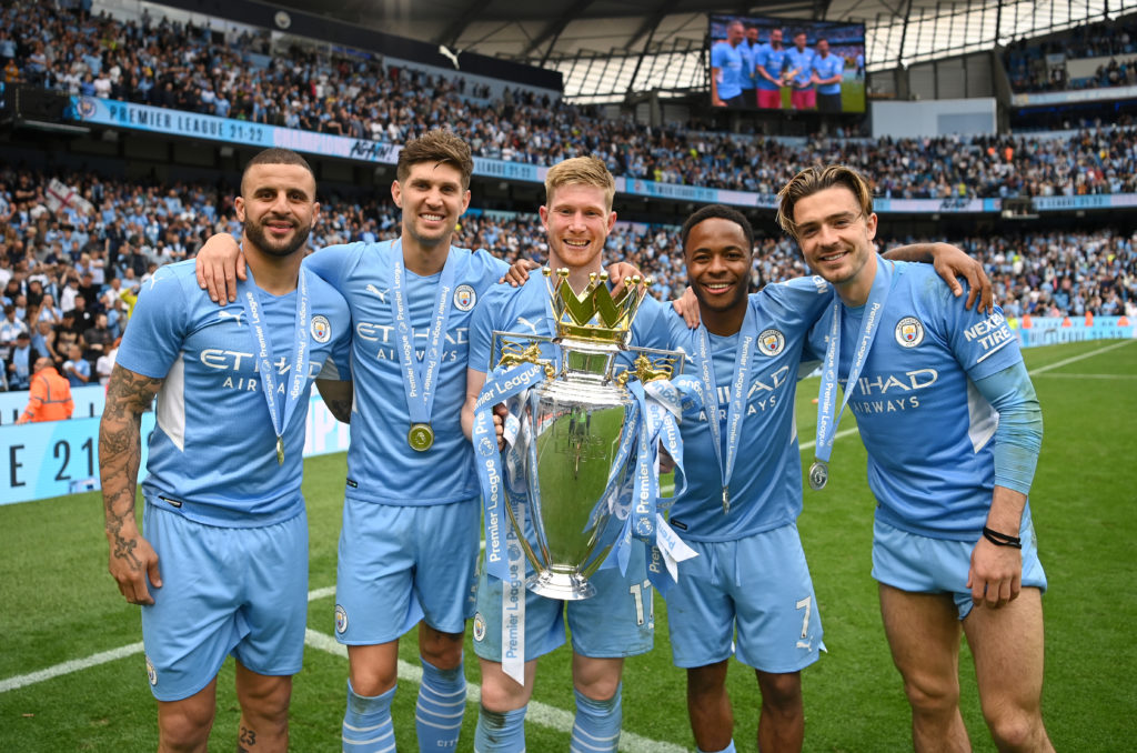 Kyle Walker and Manchester City teammates with the Premier League trophy.