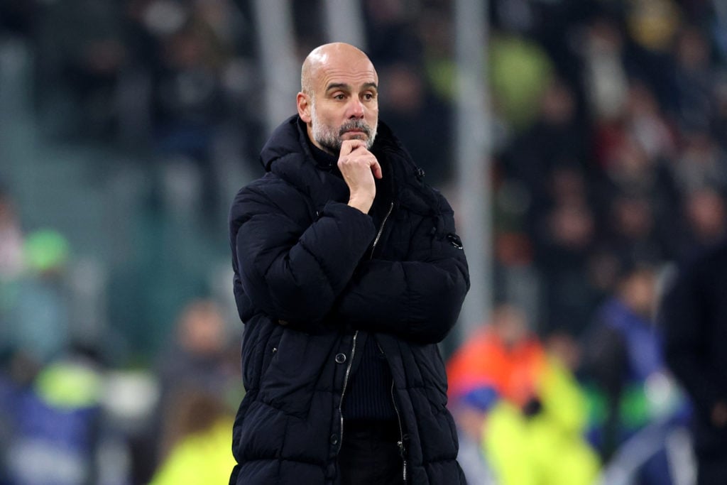 Pep Guardiola standing on the touchline during Manchester City vs Juventus
