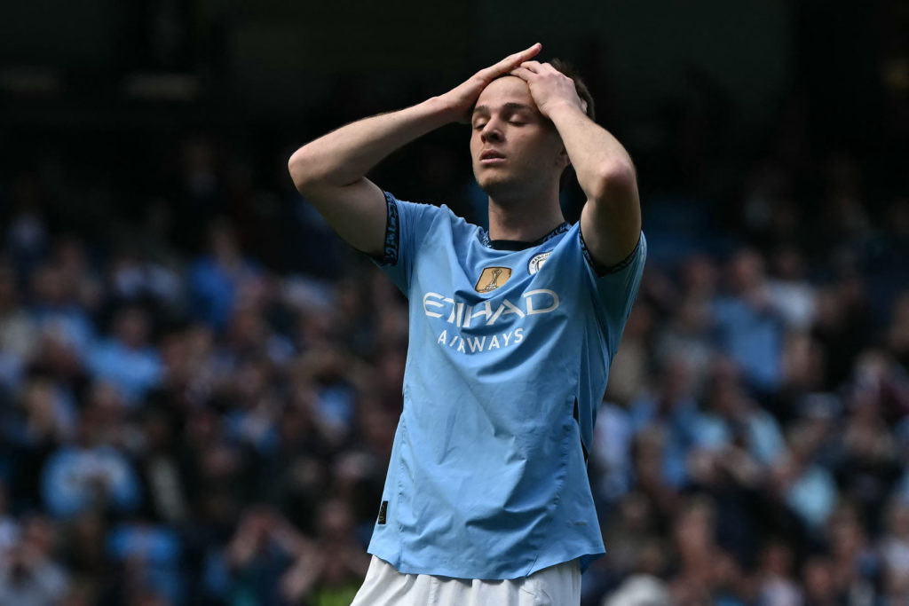Man City's James McAtee wit his hands on his head.