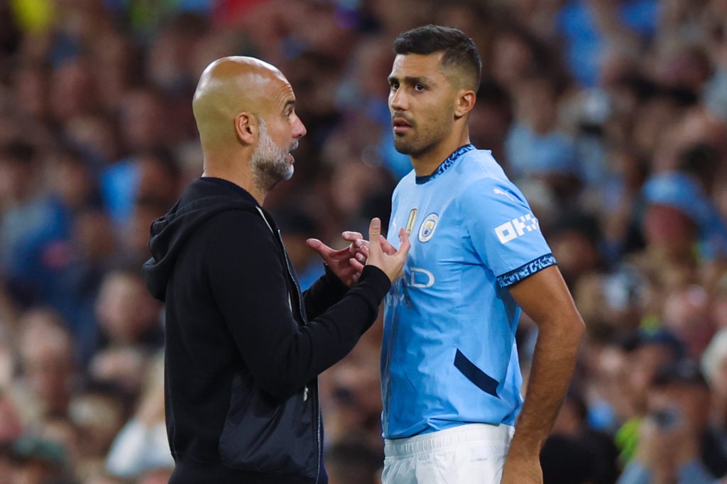 Rodri and Pep Guardiola in conversation during Manchester City vs Bournemouth.