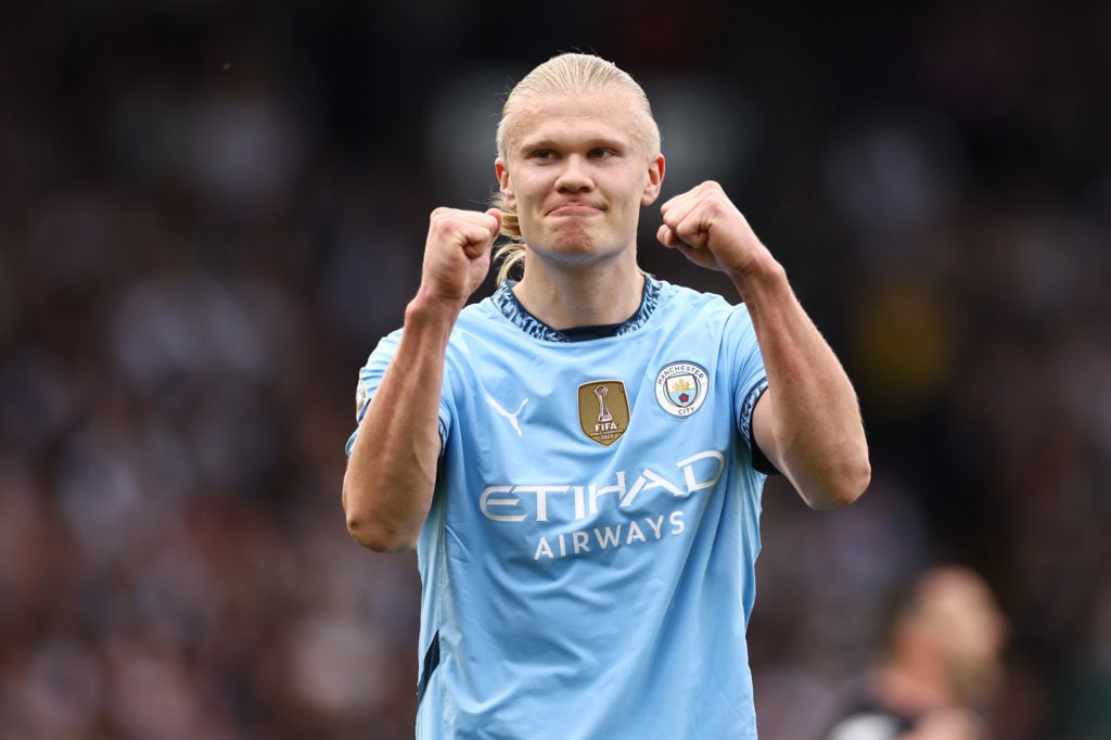 Erling Haaland with his arms raised during Fulham v Manchester City.