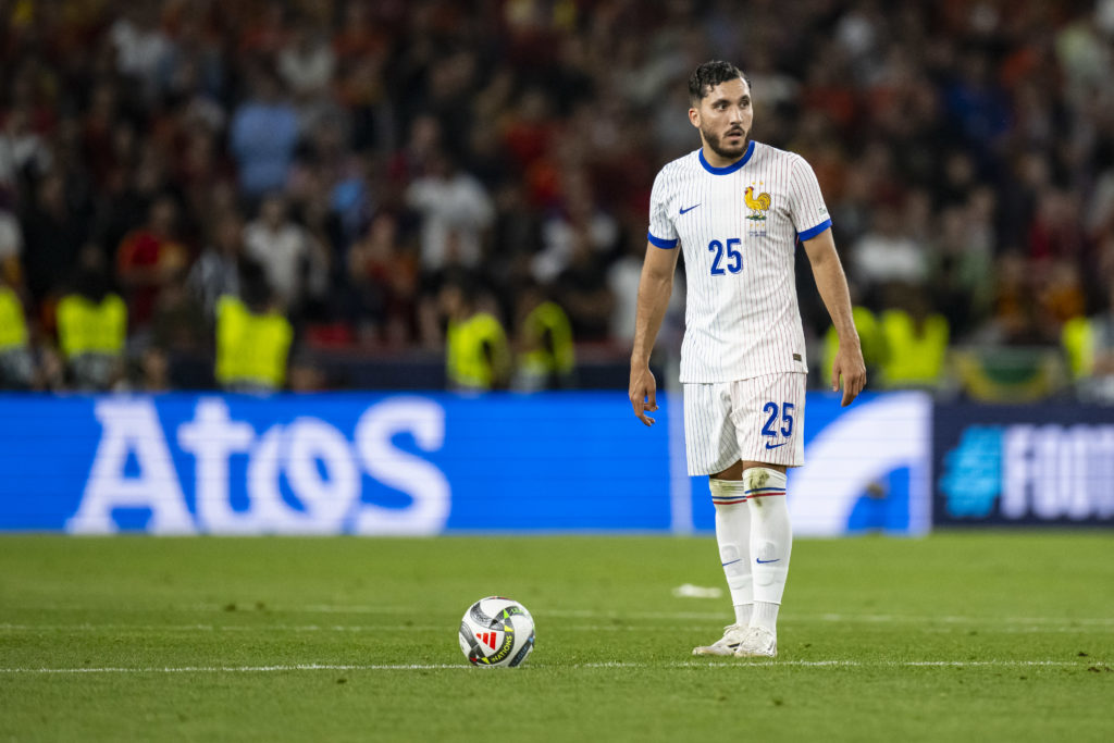 Rayan Cherki stands over a free-kick for France.