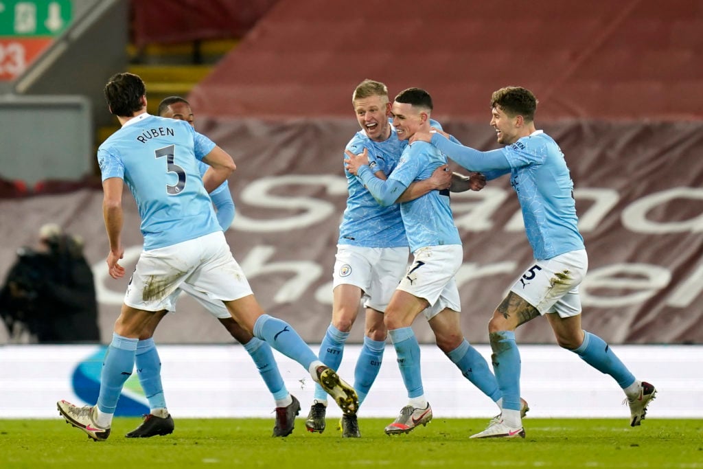 Phil Foden celebrates with his Man City teammates after scoring against Liverpool.