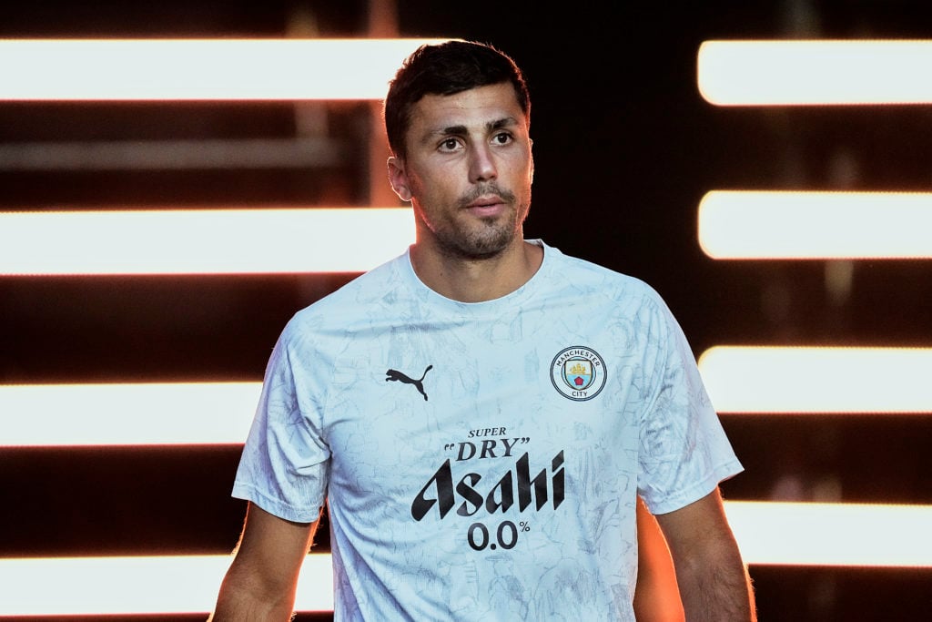 Rodri looks on ahead of warming up for Manchester City.