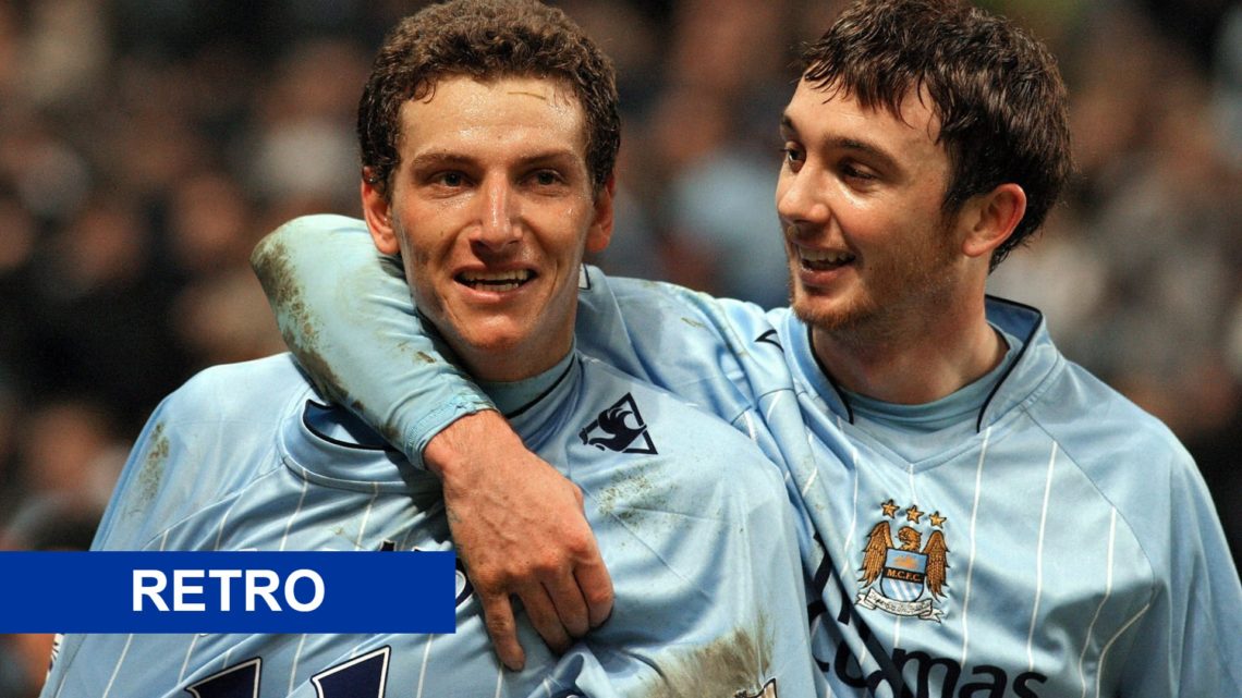 Elano celebrating a goal with former Man City teammate Stephen Ireland (main image) blue retro tag (bottom left corner)