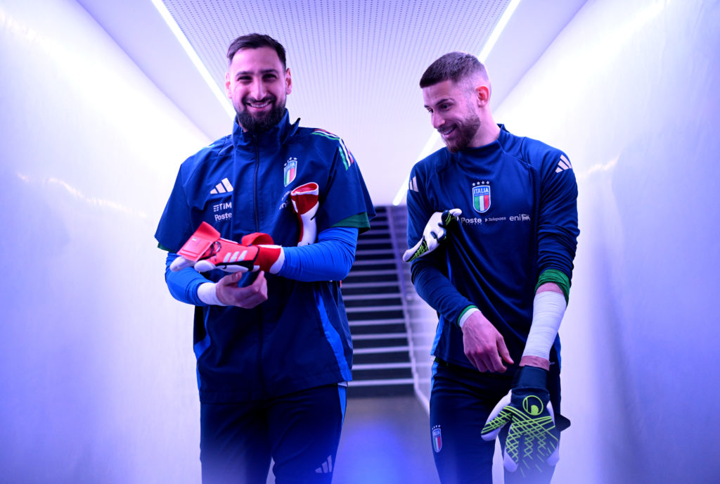Gianluigi Donnarumma and Guglielmo Vicario of Italy talk in the tunnel area ahead of the warm up prior to the UEFA Nations League quarterfinal leg one match between Italy and Germany at Stadio San Siro on March 20, 2025