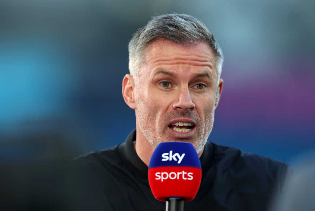 Jamie Carragher speaks into a Sky Sports microphone before Manchester City v Wolverhampton Wanderers.