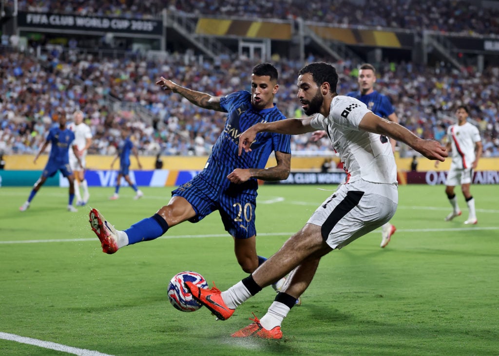 Rayan Ait-Nouri #21 of Manchester City attempts a shot as Joao Cancelo #20 of Al Hilal defends during the FIFA Club World Cup 2025 round of 16 match between Manchester City and Al-Hilal at Camping World Stadium on June 30, 2025