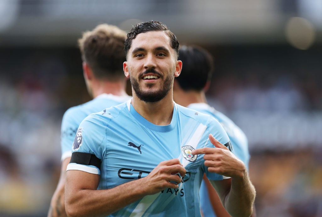 Rayan Cherki points to the Man City badge during Wolverhampton Wanderers v Manchester City.