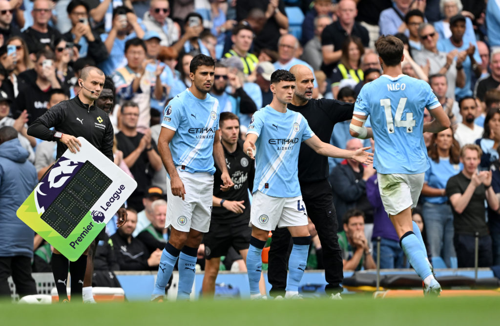 Phil Foden and Rodri prepare to come on for Manchester City against Tottenham
