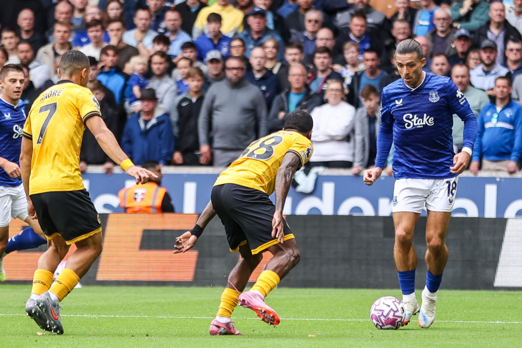 Everton's Jack Grealish is in attacking action with the ball as Wolverhampton Wanderers' Jackson Tchatchoua positions to intercept during the Premier League match between Wolverhampton Wanderers and Everton at Molineux in Wolverhampton, England, on August 30, 2025.