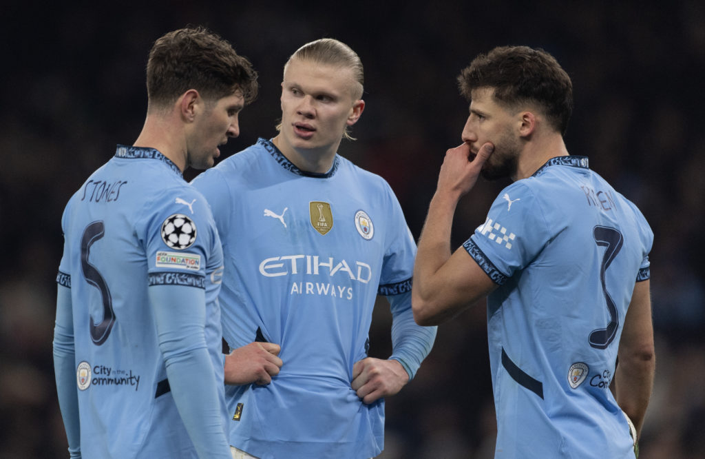 Erling Haaland of Manchester City with Ruben Dias and John Stones during the UEFA Champions League 2024/25 League Knockout Play-off first leg match between Manchester City and Real Madrid C.F. at Manchester City Stadium on February 11, 2025