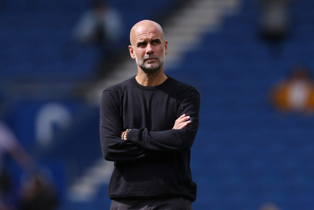 A focused Pep Guardiola looks on ahead of Brighton vs Manchester City