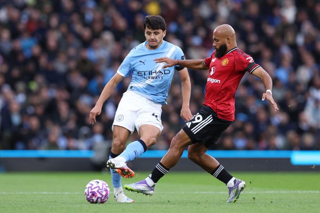Abdukodir Khusanov and Bryan Mbeumo in action during Manchester City v Manchester United