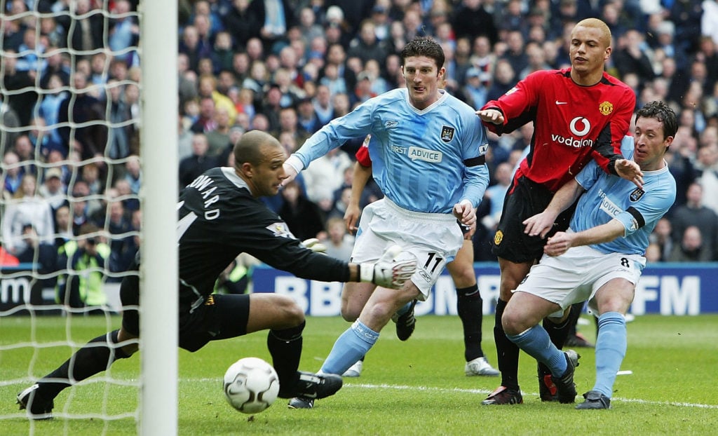 Robbie Fowler of Man City scores the opening goal past Tim Howard of Man Utd during the FA Barclaycard Premiership match between Manchester City and Manchester United at The City of Manchester Stadium on March 14, 2004