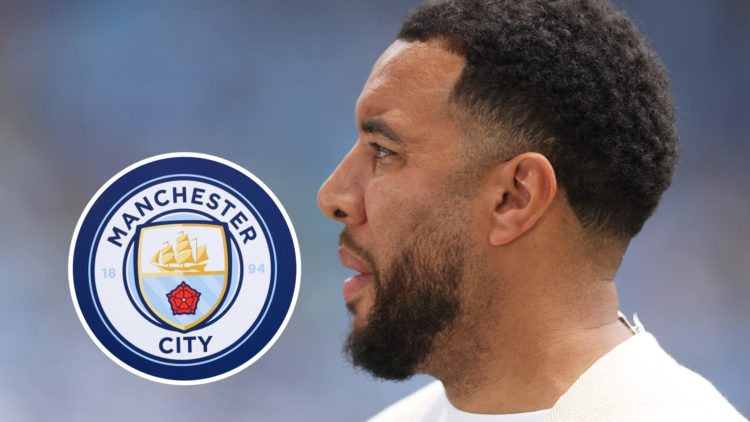 A side shot of Troy Deeney working as a pundit (main image) inset of the Man City badge (bottom right corner)