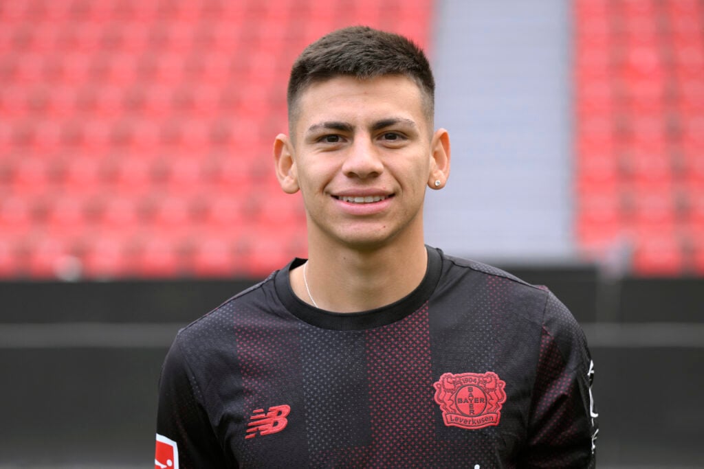 Claudio Echeverri poses in a Bayer Leverkusen shirt.