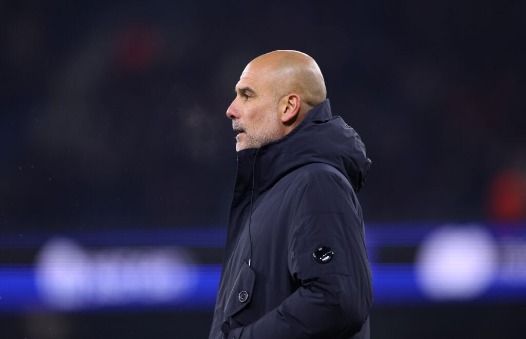 Manchester City manager Pep Guardiola looks on.