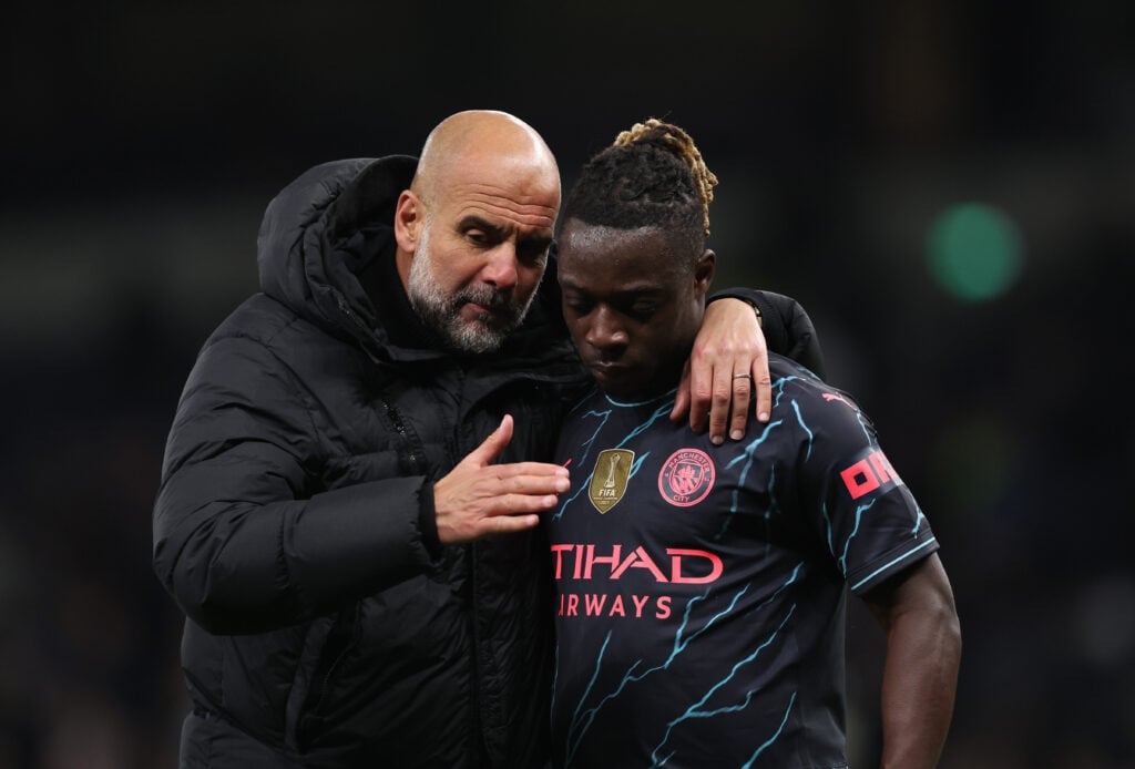 Pep Guardiola speaks with Jeremy Doku.