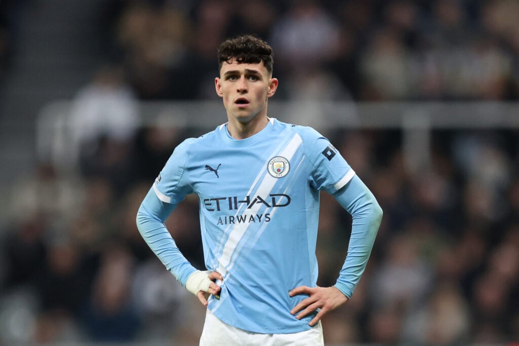 Phil Foden puts his hands on his hips.