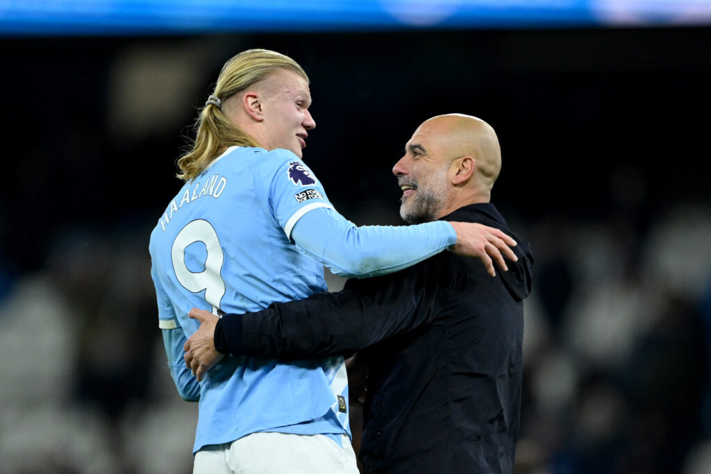 Pep Guardiola and Erling Haaland embrace.