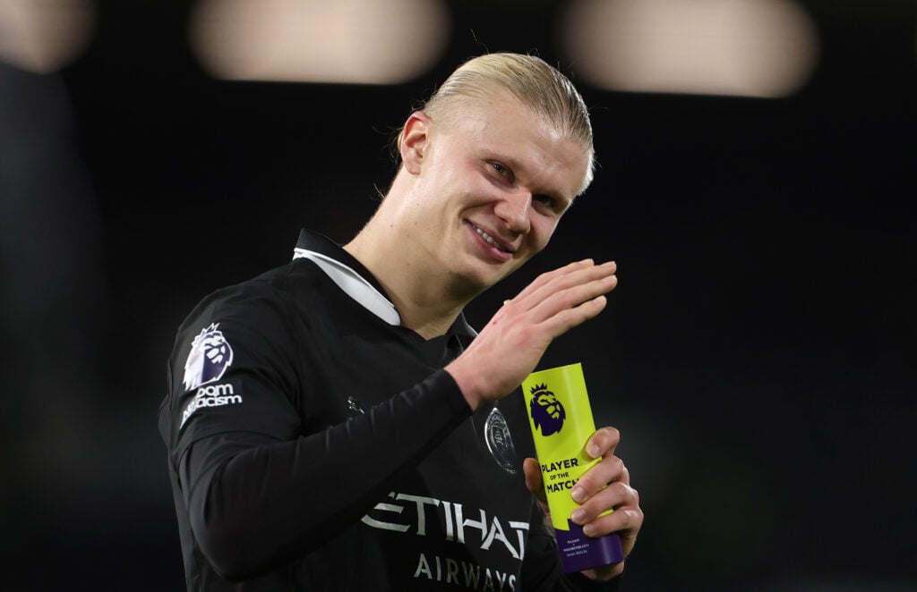 Erling Haaland poses with his Player of the Match trophy.