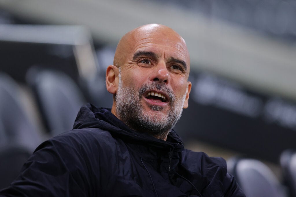 Manchester City manager Pep Guardiola looks on.