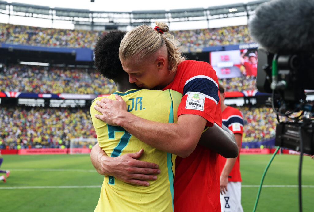 Vinicius Jr hugs Erling Haaland.